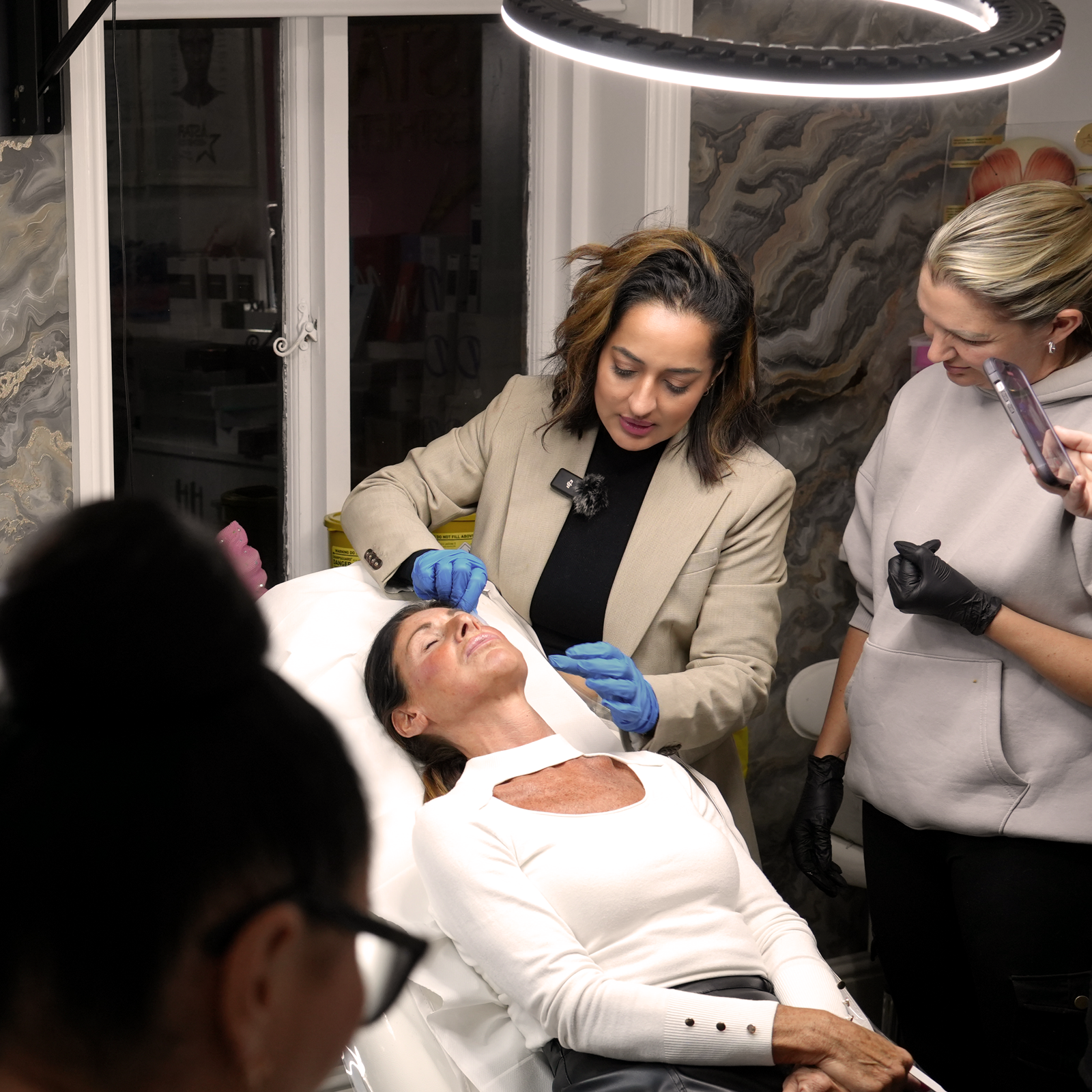 Nita McEvoy performing and teaching advanced injectable aesthetic treatment on a patient in her North London clinic